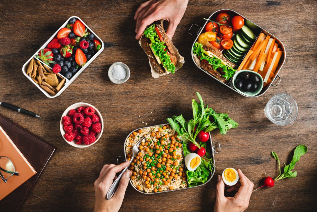 People having balanced diet from lunch boxes - Saffron4health